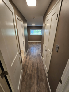 A renovated hallway featuring new wood-look tile flooring installed by AIS Home Service's in St. Louis, MO.