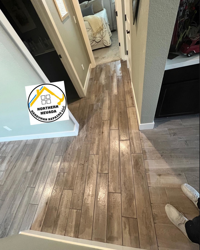 A newly installed wood-look tile flooring in a hallway by Northern Nevada Handyman Repairs LLC in Reno, NV