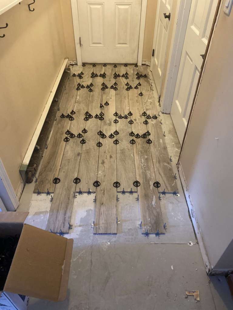 Hallway wood-look tile installation in progress by Main Street Handyman, LLC in Winter Garden, FL.