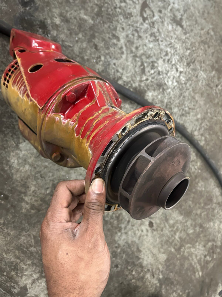 A hand holding a pump impeller during repair by Comfort Mechanical Heating and Cooling in Ann Arbor, MI.