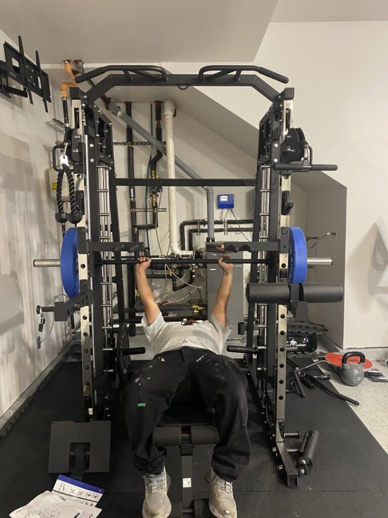A handyman from The Handy Nevadan LLC assembling home gym equipment in Reno, NV.