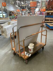 A handyman from The Handy Nevadan LLC purchasing drywall and supplies at a hardware store in Reno, NV.