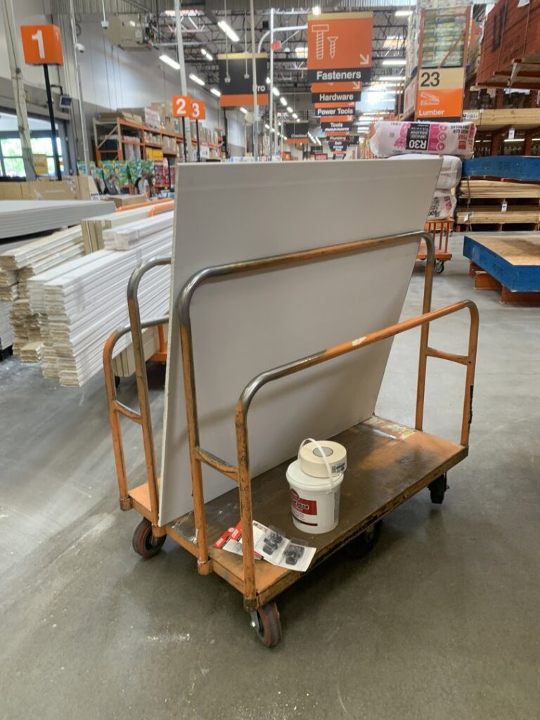 A handyman from The Handy Nevadan LLC purchasing drywall and supplies at a hardware store in Reno, NV.