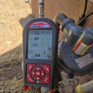 A handyman from Mock-n-Son Inc. in Rio Rancho, NM, uses a cable testing diagnostic tool showing a "FAIL" result.