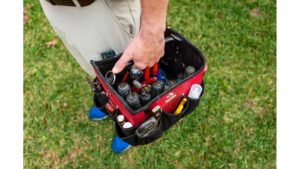 A handyman carrying a red tool bag filled with tools for Advanced Rooter Plumbing in Norwalk, CT