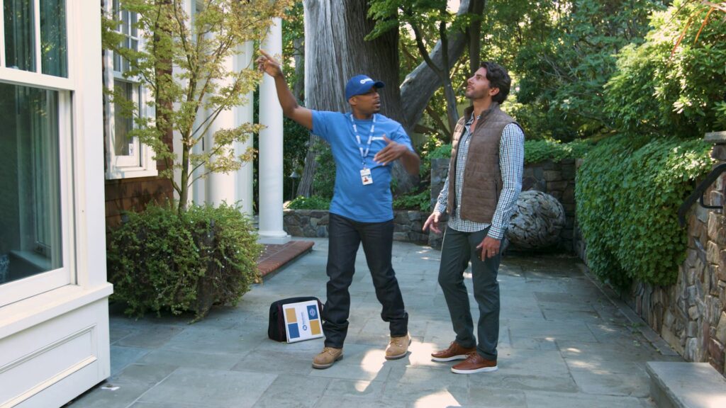 A Handyman Connection of Wichita East professional consults with a client outdoors in Wichita, KS.