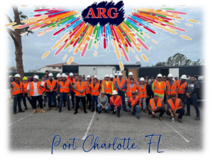 American Relief Group (ARG) handyman crew in hard hats and safety vests at a work site in Kenner, LA