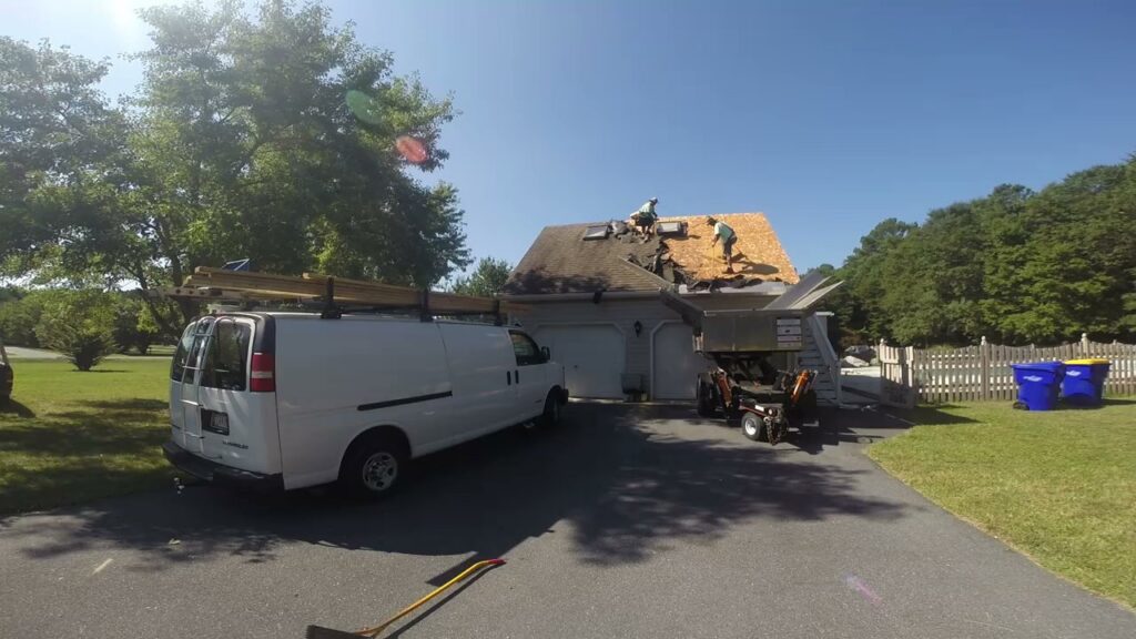 A handyman crew working on a roof replacement project for Bayside Exteriors in Lewes, DE.