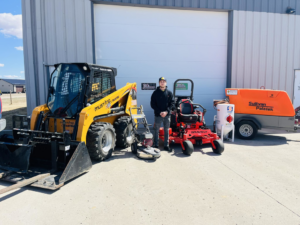 A handyman with a skid steer, sandblaster, and other equipment for various services at JB's Mowing & Misc Services in Aberdeen, SD.