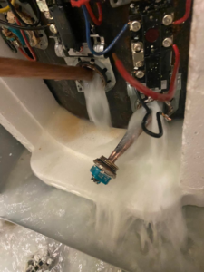 A handyman from Handyman Al fixing a leaking appliance with water and foam spraying from a component in Rapid City, SD.