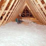 A handyman installing blown-in attic insulation in a home for Miami Valley Insulation Co LLC in Dayton, OH.