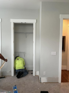 A handyman from Special Reserve Contracting installing custom wire shelving inside a closet in Charlotte, NC.