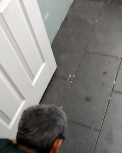 A handyman from Northern Elite Remodeling LLC installing new floor tiles in Bloomfield, NJ.