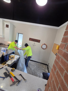 Handyman professionals installing new flooring at Carpet Hut by McDrake in Virginia Beach, VA.