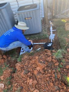 A handyman from Silver Landscaping & Construction installing an irrigation system in Knoxville, TN