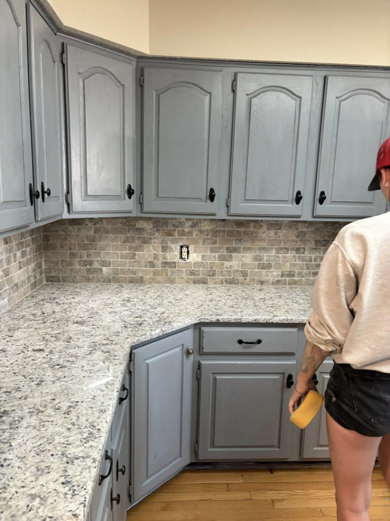 A handyman installing kitchen backsplash and working on cabinets for Express Handyman Pros, LLC in Fort Smith, AR