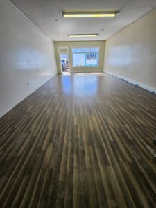 A handyman installing new laminate flooring for Montana Living Property Management in Helena, MT