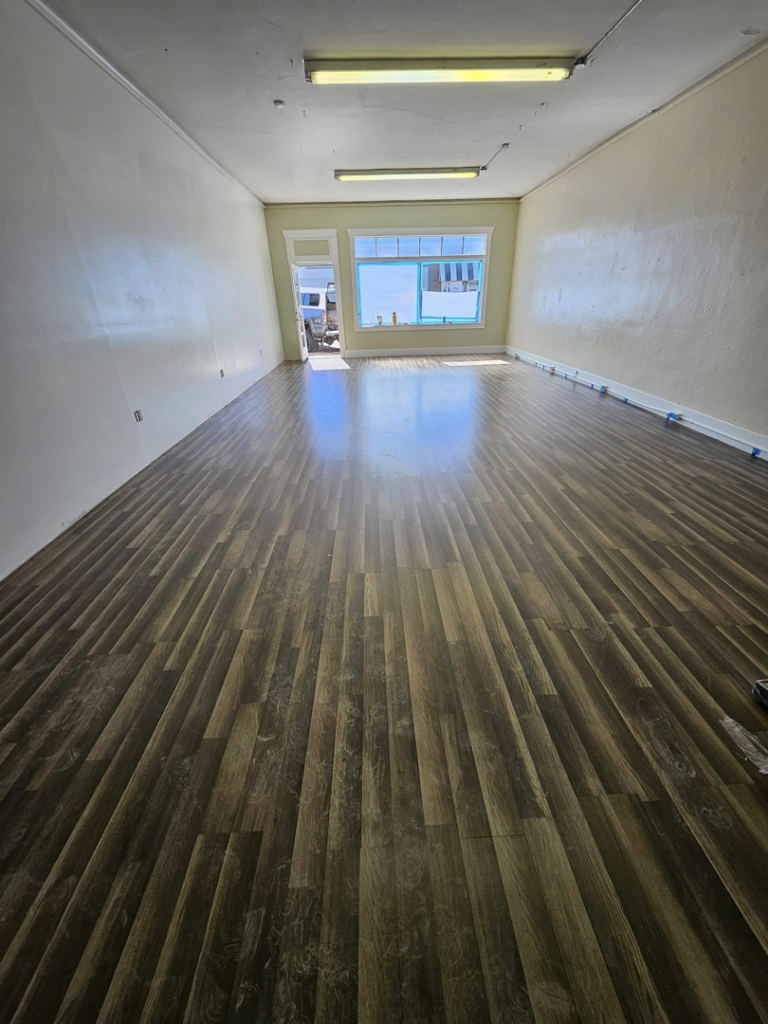 A handyman installing new laminate flooring for Montana Living Property Management in Helena, MT