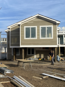 A handyman from North Landing Exteriors Inc. installing siding on a house in Virginia Beach, VA.
