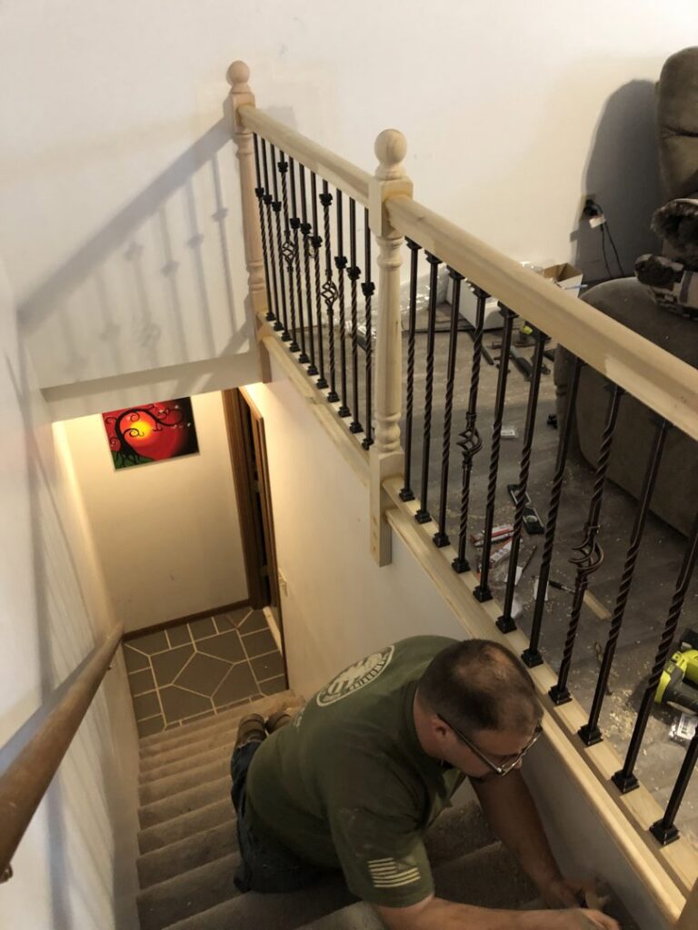 A HandyVets professional installing a new stair railing in a home in Saint Charles, MO.