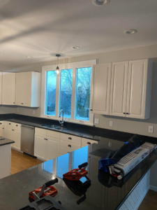Handyman tools on a black kitchen countertop during cabinet and counter installation by CoCara Remodeling LLC in O Fallon, MO.