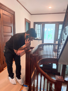 A handyman from Cambridgeport Construction on-site during a staircase renovation in Milton, MA