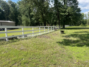 A handyman painting a white wooden fence for S&S Handyman Services in Reno, NV
