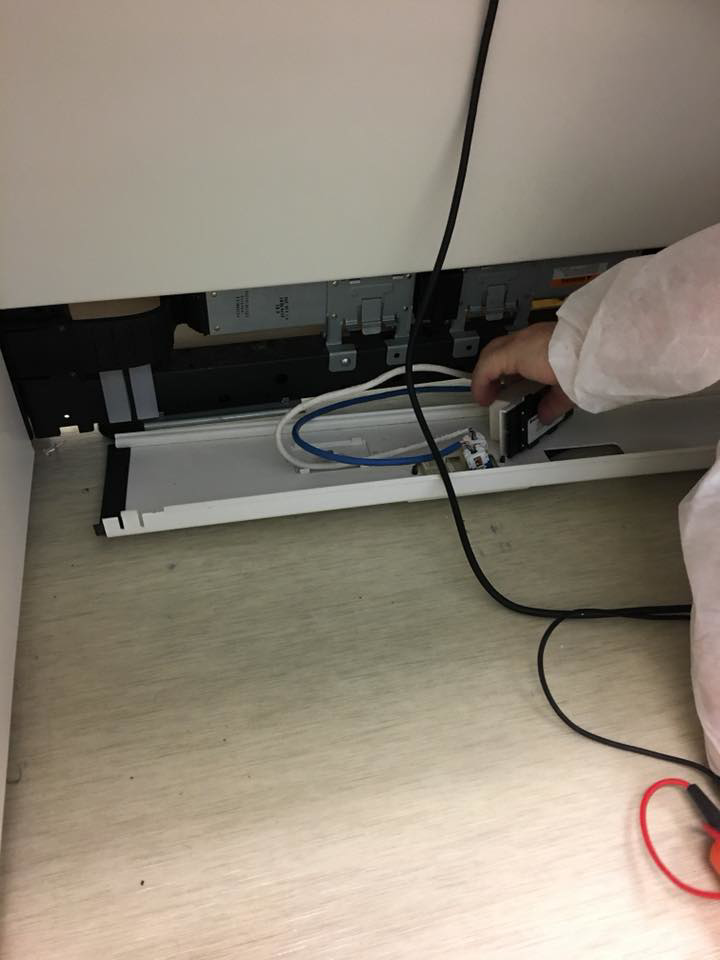A handyman repairing or installing electrical wiring and cables under a counter for Master Handyman, LLC in Cleveland, OH.