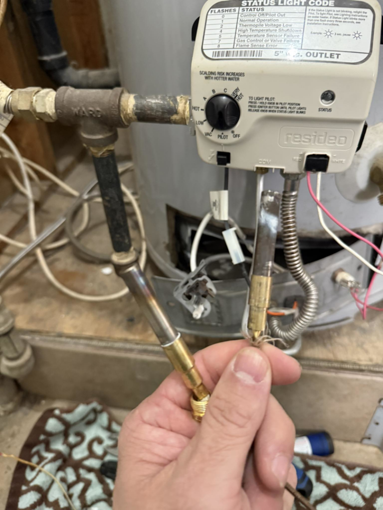 A handyman performing a repair on a water heater unit for The General Handyman in Los Angeles, CA.