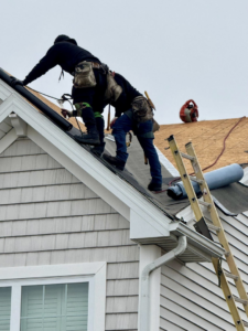 Two handyman crew members working on a roof repair project for Darby Builders in Columbus, OH.