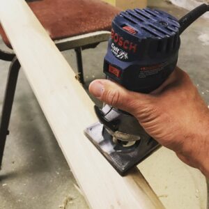 A handyman using a Bosch sander on a piece of wood for a project by Triple M Handyman in Portsmouth, NH.