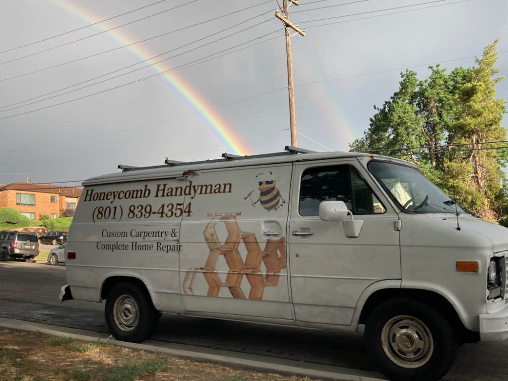A branded service van for Honeycomb Handyman Services, ready for jobs in Salt Lake City, UT.