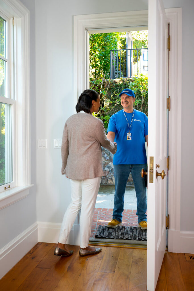 A Handyman Connection of Wichita East professional shakes hands with a client at their home in Wichita, KS.
