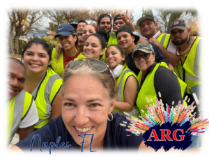 American Relief Group (ARG) handyman team in safety vests taking a group selfie in Kenner, LA