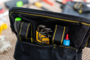 A close-up of a handyman's tool bag filled with various tools for repairs from Larry's Appliance Repair in California, MO.