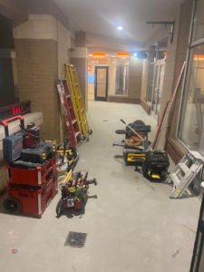 Handyman tools and equipment, including toolboxes and ladders, set up in a hallway for a job by DG Pro Remodeling in Charlotte, NC