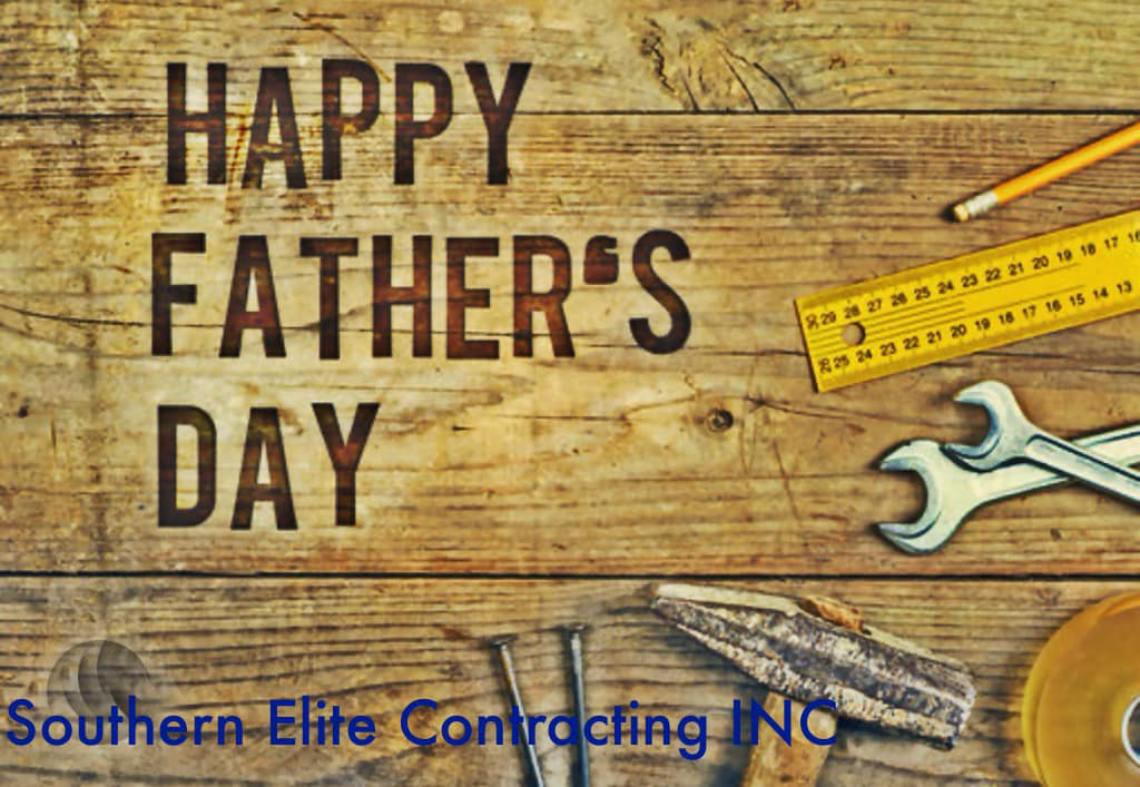 Handyman tools including a hammer, nails, wrenches, and a ruler on a wooden background for Southern Elite Contracting Athens GA in Monroe, GA.