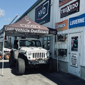The Handyman Vehicle Outfitters storefront with a Jeep and a sign advertising hitches sold and installed in Portland, ME.