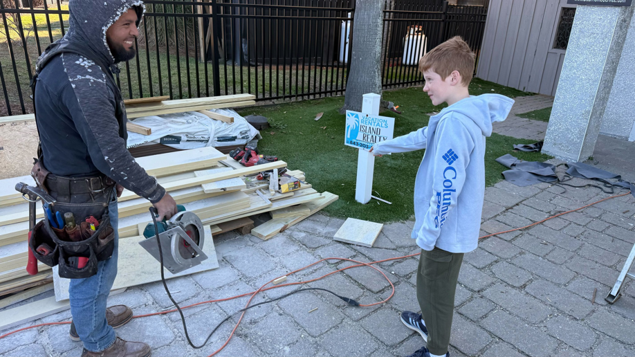 A handyman wearing a tool belt and holding a circular saw on a job site for BearHome Service in Mount Pleasant, SC