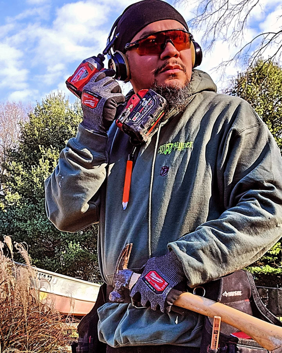 A handyman wearing safety gear and holding power tools, ready for work with DEMIA 17 & Company LLC in Waldorf, MD.