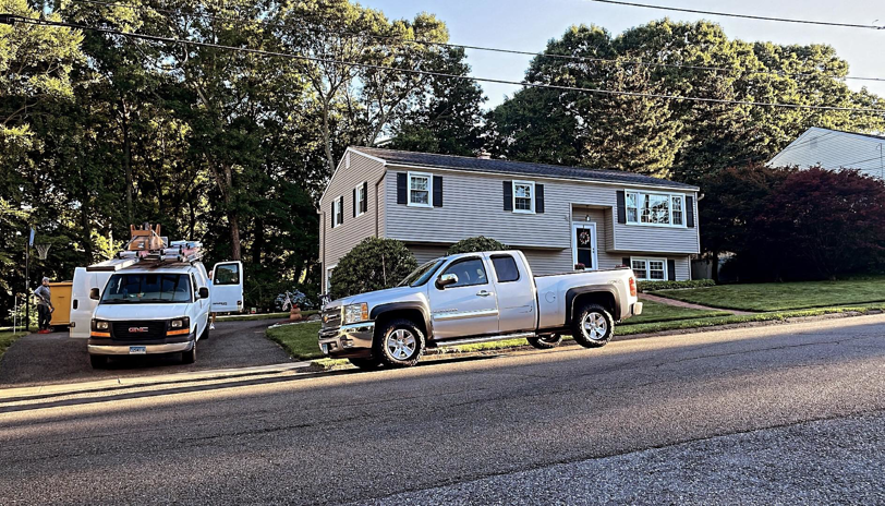 A GGS General Construction LLC work van and truck parked at a residential job site in Plano, TX, ready for handyman services.