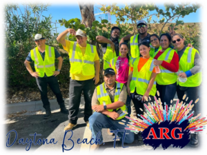 American Relief Group (ARG) handyman workers in safety vests posing outdoors in Kenner, LA