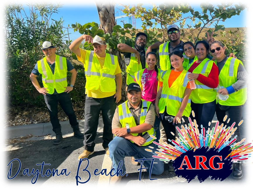 American Relief Group (ARG) handyman workers in safety vests posing outdoors in Kenner, LA