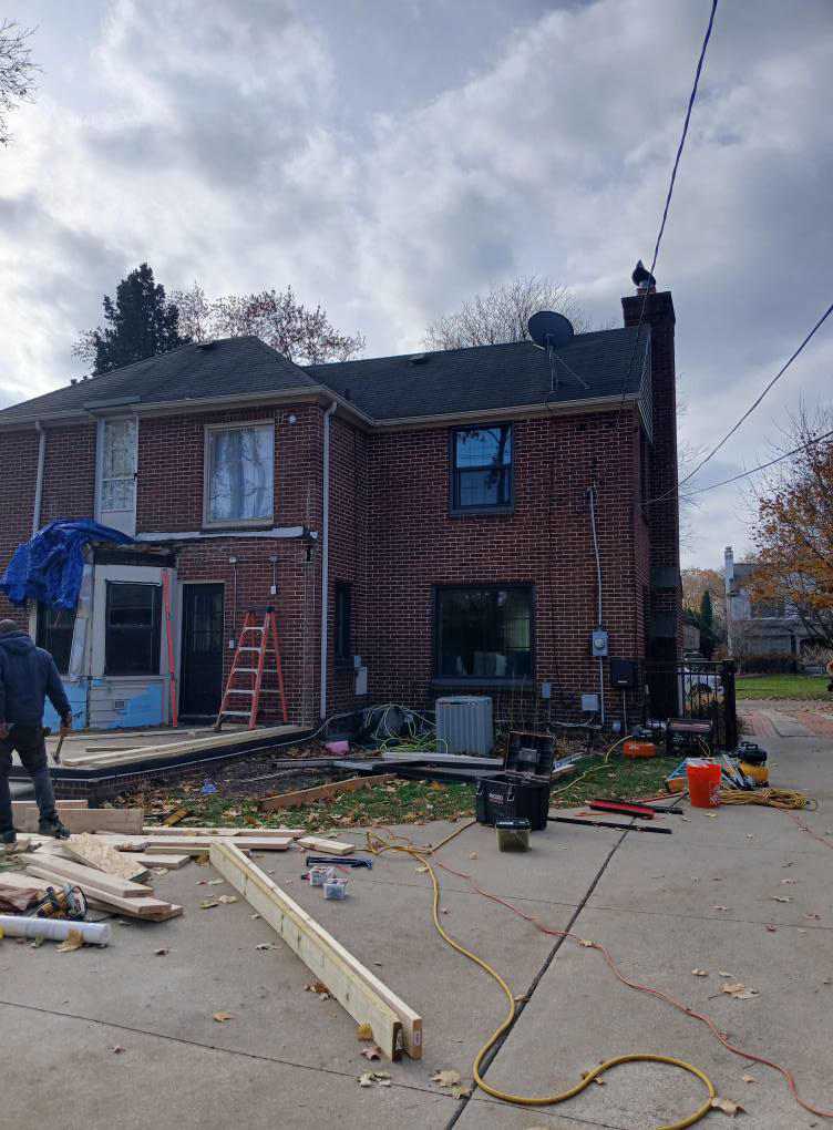 A handyman working on a deck renovation project at a house by Exterior Renovations, LLC in Clinton Township, MI.