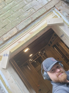 A handyman working on doorway framing during a home improvement project by JDS Home Improvement in Gaithersburg, MD.