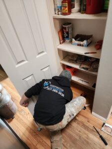 A HandyMation technician working on a pantry door or cabinet in a home in Cheyenne, WY