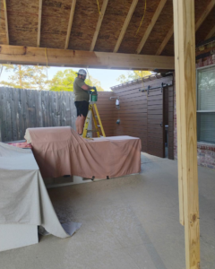 A handyman working on the construction of a new patio cover for Comeaux Home Services in Baton Rouge, LA.