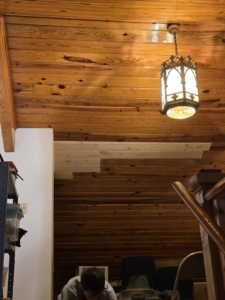 A handyman from E and C Handyman and Construction LLC working on a wooden ceiling in Owensboro, KY.