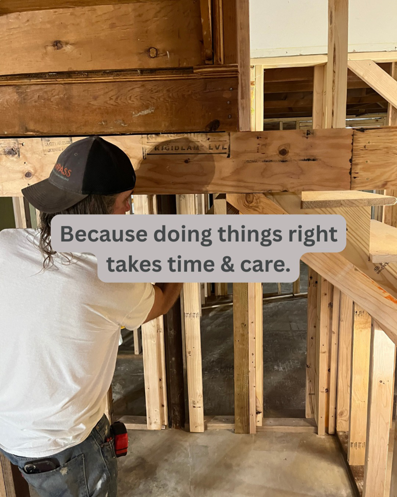 A handyman from Compass Construction & Remodeling working on wooden wall framing inside a home in Milwaukee, WI.
