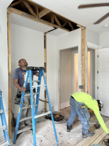 Two skilled handymen performing interior wall framing and construction work for Special Reserve Contracting in Charlotte, NC.